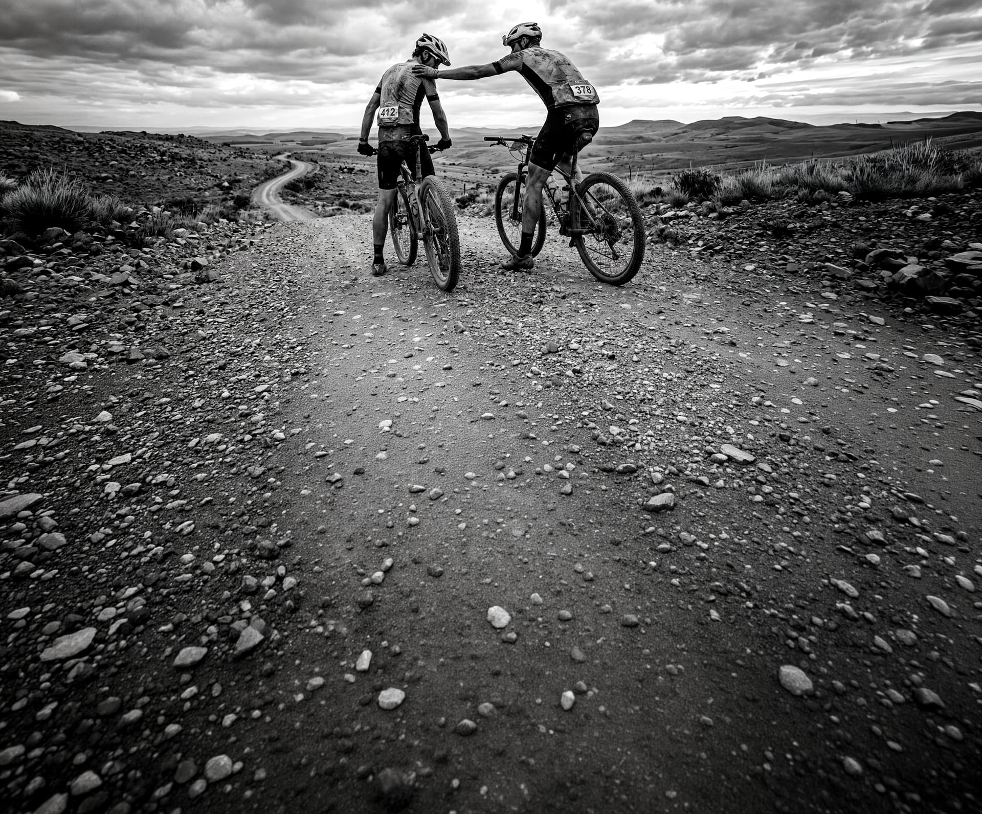 Two riders making it to the top of a steep hill on a demanding ride
